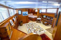 Luxurious interior of 1987 Aberdeen Marina Complex Chinese wood junk, featuring cozy seating and decor.