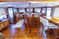 Luxurious interior of 1987 Aberdeen Marina Complex Chinese wood junk, featuring elegant wooden furnishings.