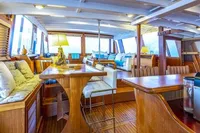 Luxurious interior of 1987 Aberdeen Marina Complex Chinese wood junk, featuring elegant wooden furnishings.