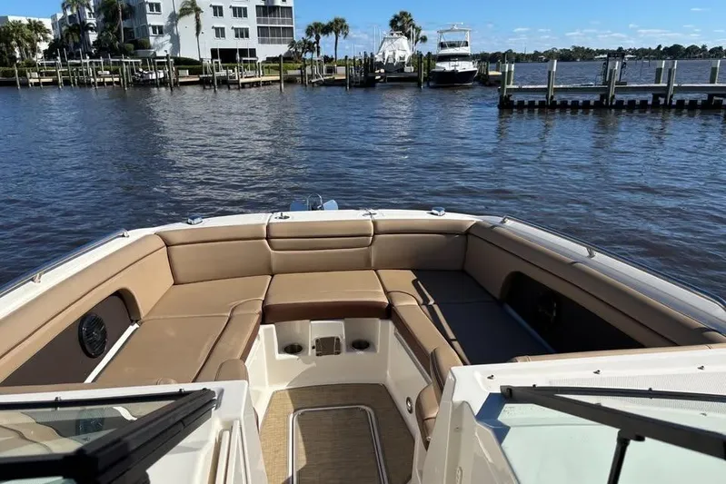  Yacht Photos Pics 2017 Sea Ray SDX 290 Outboard boat with spacious seating, docked by waterfront homes.