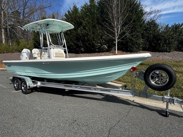 2025 Bulls Bay 2400 boat on trailer, parked outdoors, with trees in the background.