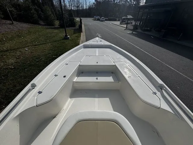 2025 Bulls Bay 2400 boat bow view, parked on a street near greenery.
