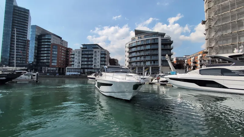 Gt50/251 Yacht Photos Pics 2025 Fairline Targa 50 GT yacht in urban marina with modern buildings.