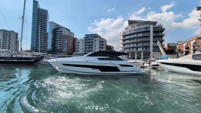 Gt50/251 Yacht Photos Pics 2025 Fairline Targa 50 GT yacht docked in a modern marina with cityscape background.