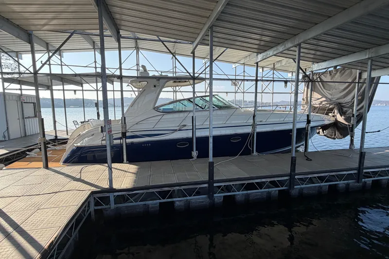  Yacht Photos Pics 2005 Formula 48 Yacht docked under a covered marina on a sunny day.
