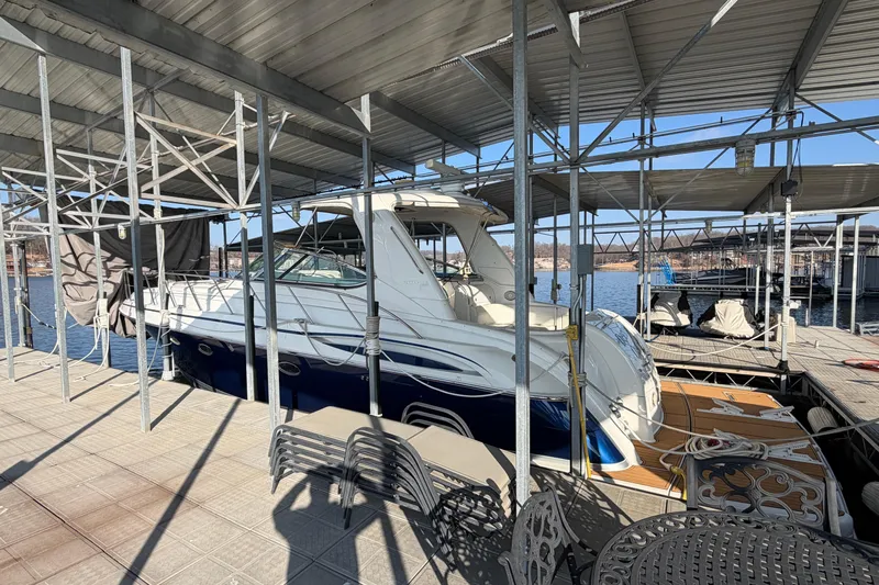  Yacht Photos Pics 2005 Formula 48 Yacht docked under covered marina with metal framework.