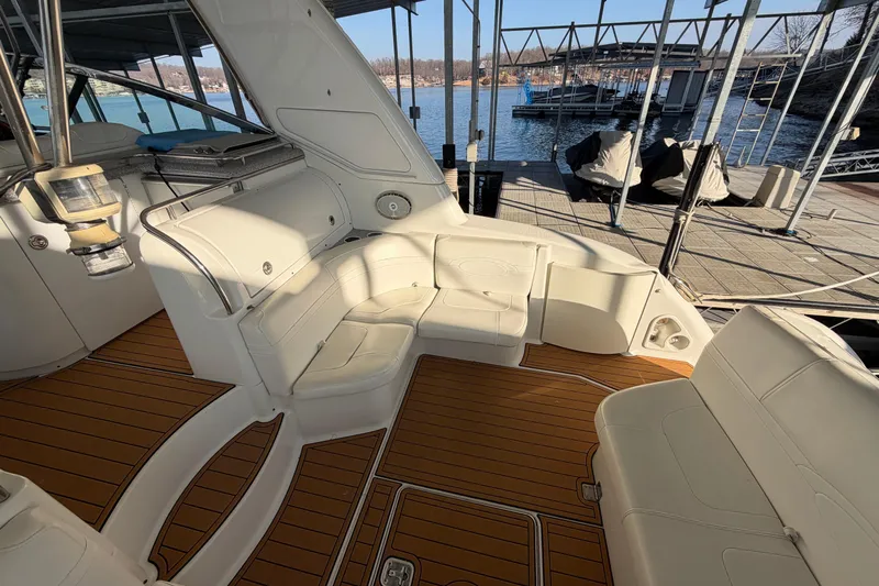  Yacht Photos Pics Luxurious 2005 Formula 48 Yacht interior with white seating and wooden flooring at a marina.