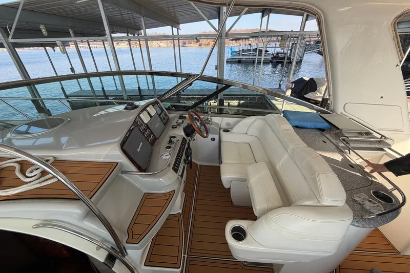  Yacht Photos Pics 2005 Formula 48 Yacht cockpit with luxurious seating and modern controls, docked by the water.