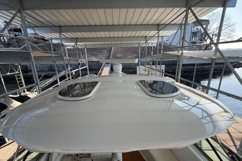  Yacht Photos Pics 2005 Formula 48 Yacht under covered dock, showcasing sleek design and dual sunroofs.