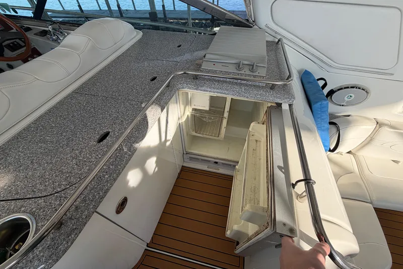  Yacht Photos Pics 2005 Formula 48 Yacht interior with open fridge, granite countertop, and white seating.