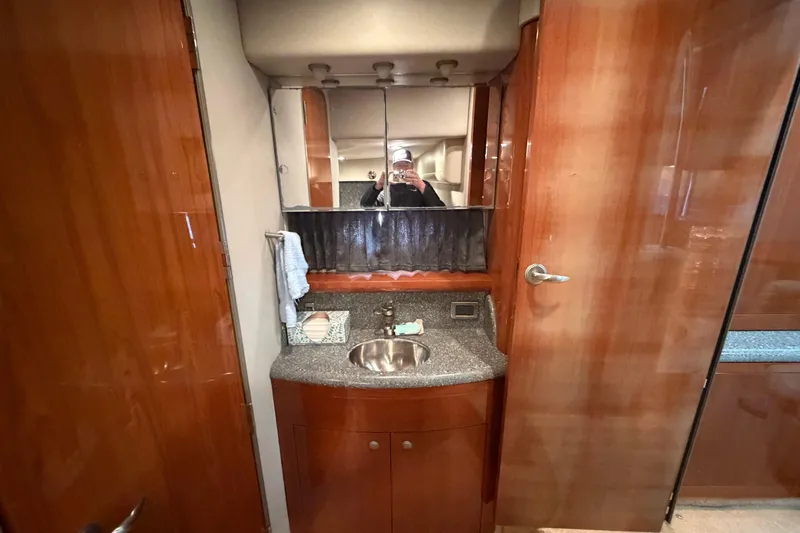  Yacht Photos Pics 2005 Formula 48 Yacht bathroom with wooden cabinetry and mirrored vanity.