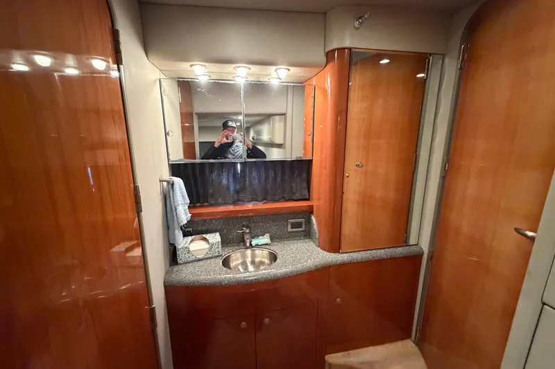  Yacht Photos Pics Luxurious bathroom interior of a 2005 Formula 48 Yacht with wooden cabinetry and modern fixtures.