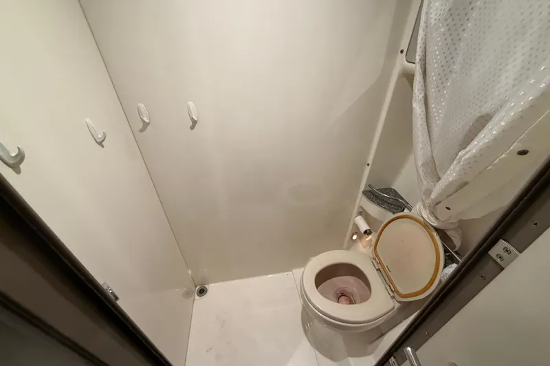  Yacht Photos Pics Bathroom interior of a 2005 Formula 48 Yacht, featuring a compact toilet and shower area.