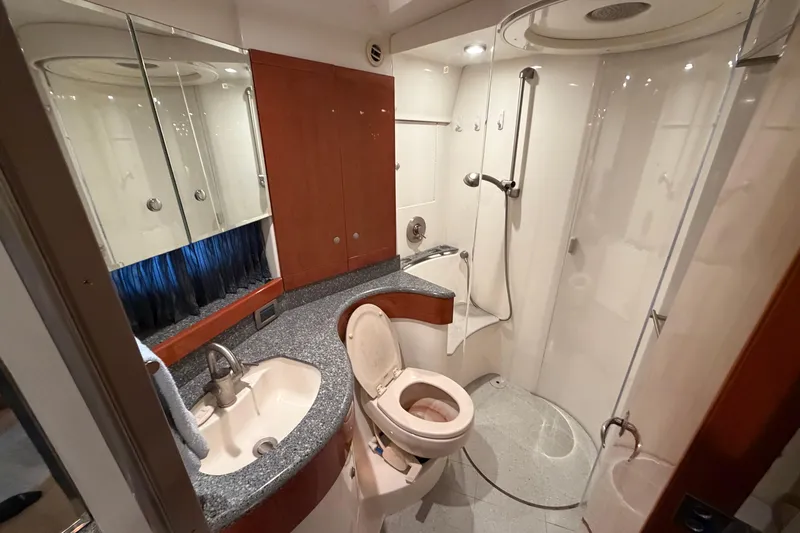  Yacht Photos Pics Luxurious bathroom in 2005 Formula 48 Yacht with shower, sink, and toilet.