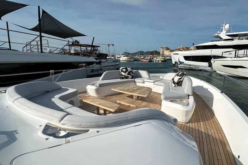  Yacht Photos Pics Luxurious 2025 Princess S80 yacht deck with elegant seating and scenic marina view.