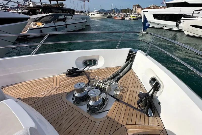  Yacht Photos Pics Bow view of 2025 Princess S80 yacht docked in marina, featuring teak deck and winches.