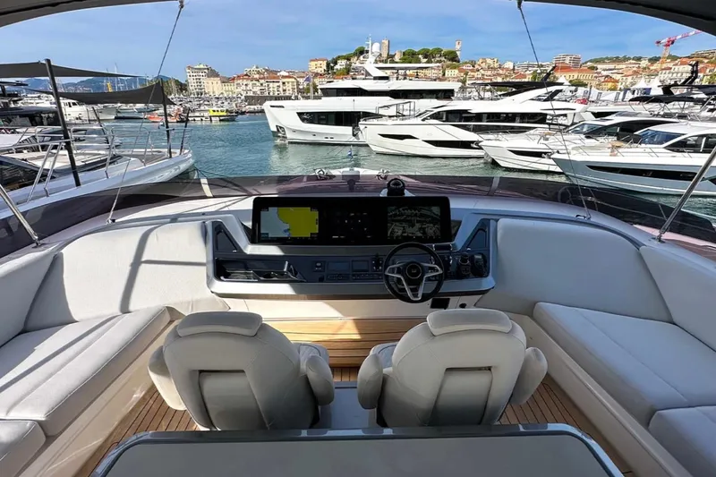  Yacht Photos Pics Luxurious 2025 Princess S80 yacht cockpit with modern controls, docked in a scenic marina.