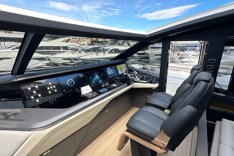  Yacht Photos Pics Luxurious 2025 Princess S80 yacht cockpit with advanced navigation displays and plush seating.