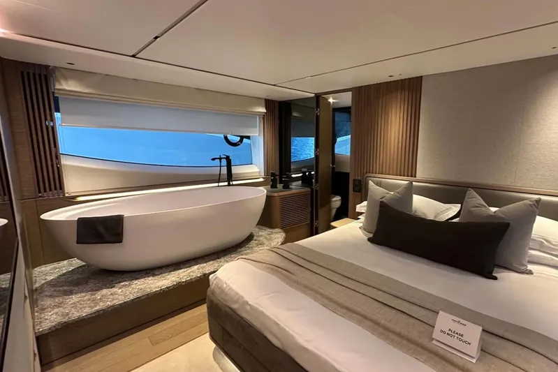  Yacht Photos Pics Luxurious 2025 Princess S80 yacht interior with elegant bedroom and freestanding bathtub.