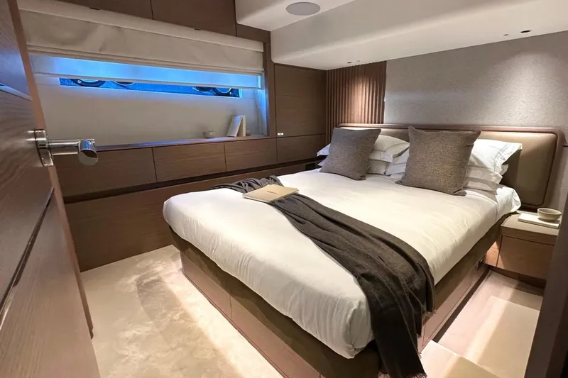  Yacht Photos Pics Luxurious bedroom interior of 2025 Princess S80 yacht, featuring elegant bedding and modern design.