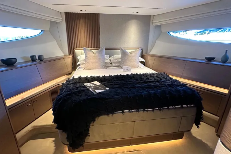  Yacht Photos Pics Luxurious bedroom interior of 2025 Princess S80 yacht with elegant decor and ambient lighting.