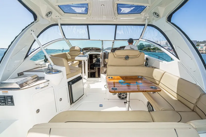 Cruel Summer Yacht Photos Pics Luxurious 2012 Cruisers 380 Express yacht interior with seating and table, overlooking the ocean.