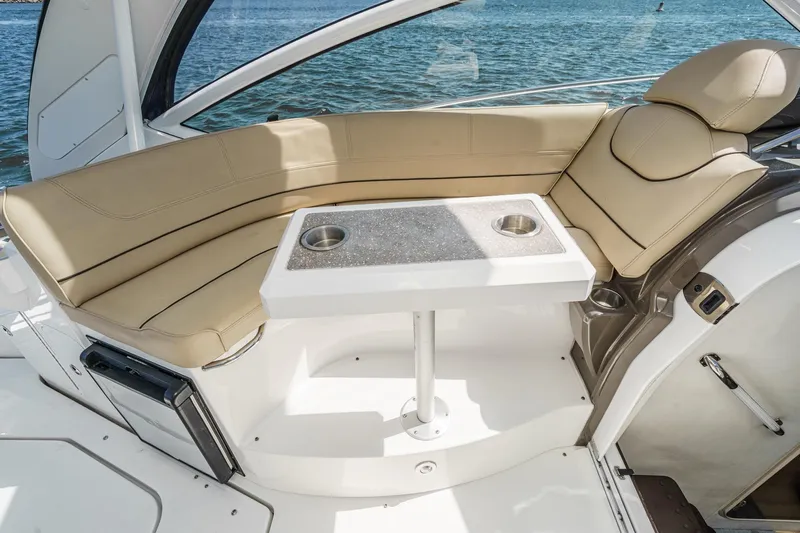 Cruel Summer Yacht Photos Pics 2012 Cruisers 380 Express boat interior with beige seating and table, overlooking water.