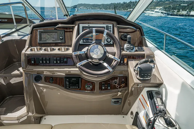 Cruel Summer Yacht Photos Pics 2012 Cruisers 380 Express helm with modern controls and navigation system, overlooking the ocean.