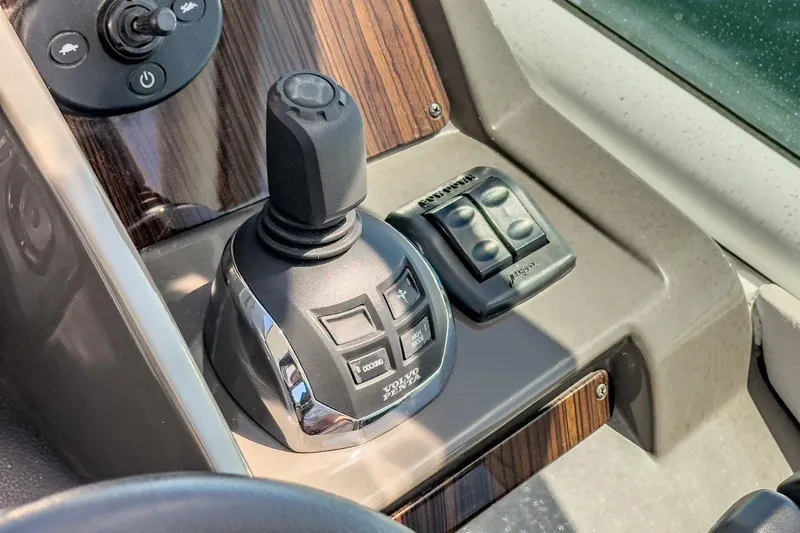 Cruel Summer Yacht Photos Pics Control panel of 2012 Cruisers 380 Express boat with joystick and buttons.