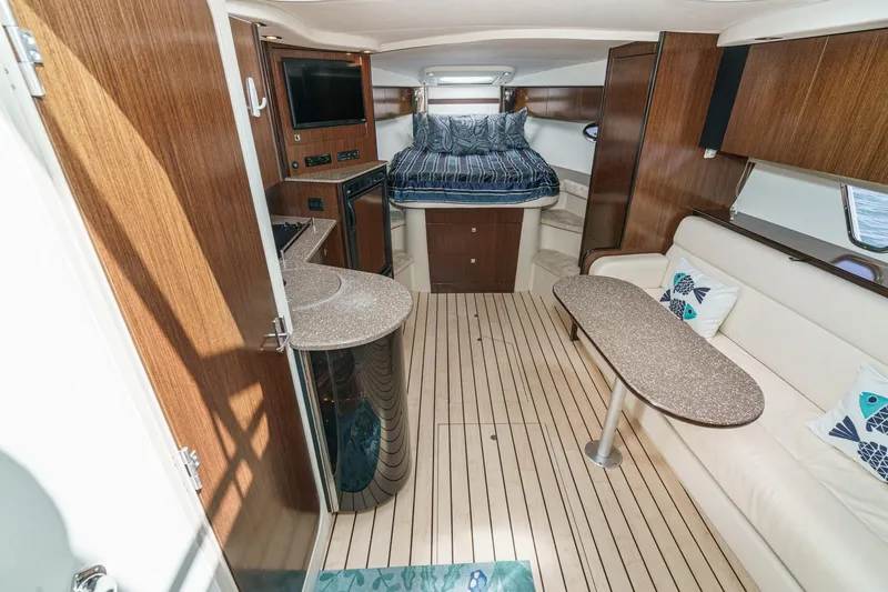 Cruel Summer Yacht Photos Pics Luxurious interior of 2012 Cruisers 380 Express yacht with wood finishes and cozy seating.