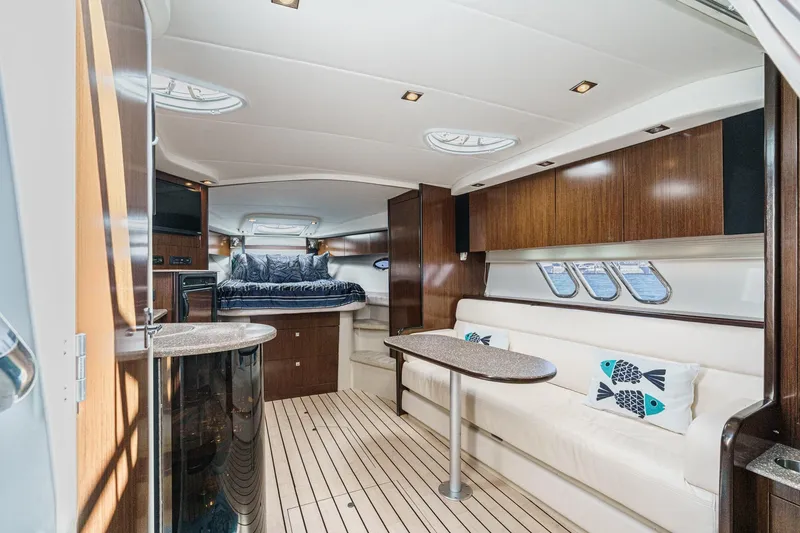 Cruel Summer Yacht Photos Pics Luxurious interior of 2012 Cruisers 380 Express yacht with elegant wood finishes and plush seating.