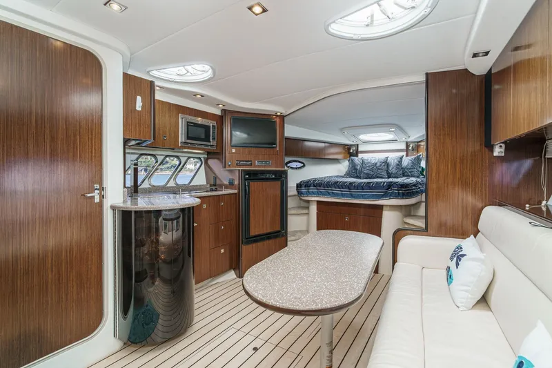 Cruel Summer Yacht Photos Pics Luxurious 2012 Cruisers 380 Express yacht interior with modern kitchen and cozy sleeping area.