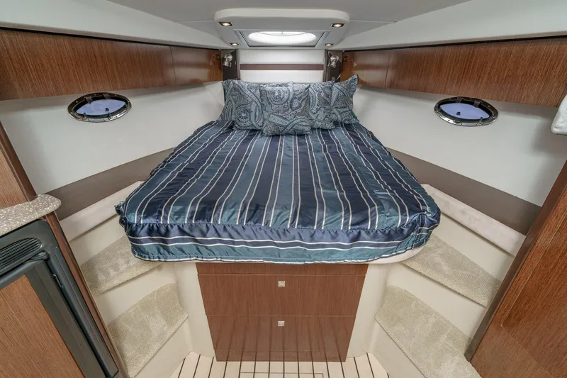 Cruel Summer Yacht Photos Pics 2012 Cruisers 380 Express cabin with cozy bed and elegant wood finish.
