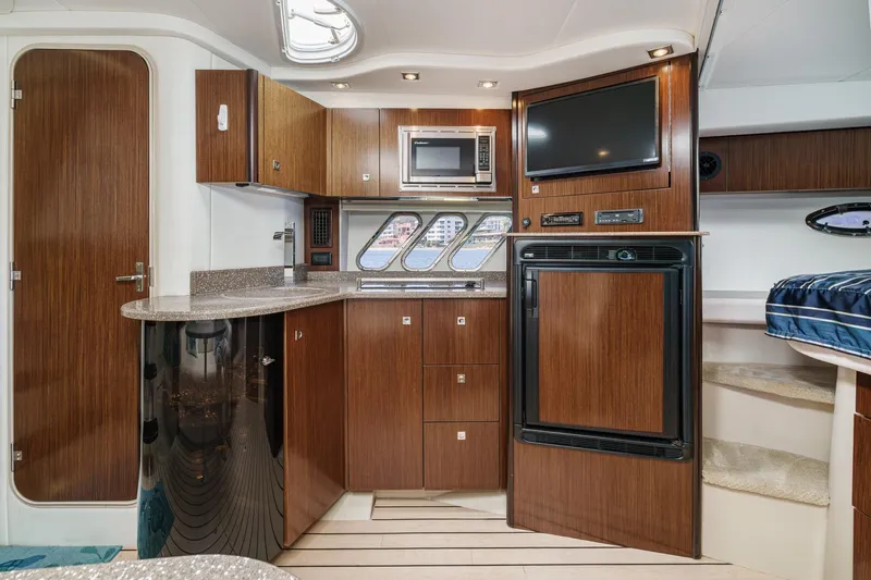 Cruel Summer Yacht Photos Pics Luxurious 2012 Cruisers 380 Express yacht interior with modern kitchen and entertainment area.