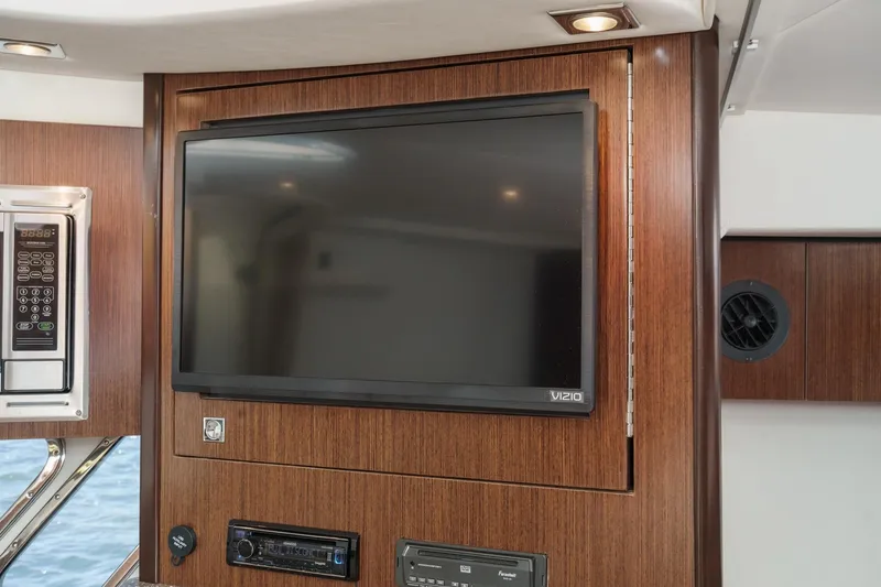Cruel Summer Yacht Photos Pics 2012 Cruisers 380 Express interior with TV and microwave, wood paneling.