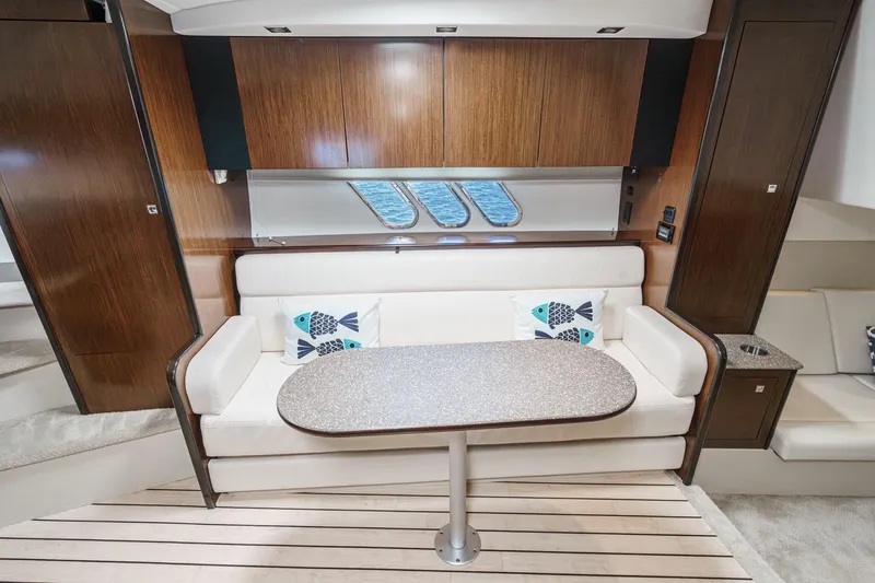 Cruel Summer Yacht Photos Pics Luxurious 2012 Cruisers 380 Express yacht interior with elegant seating and table.