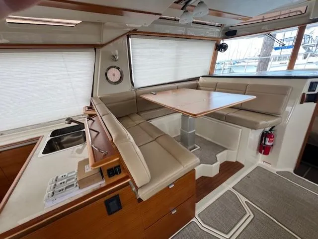 Seahorse Yacht Photos Pics 2019 Ranger Tugs R-41 CB interior with dining area and beige seating.