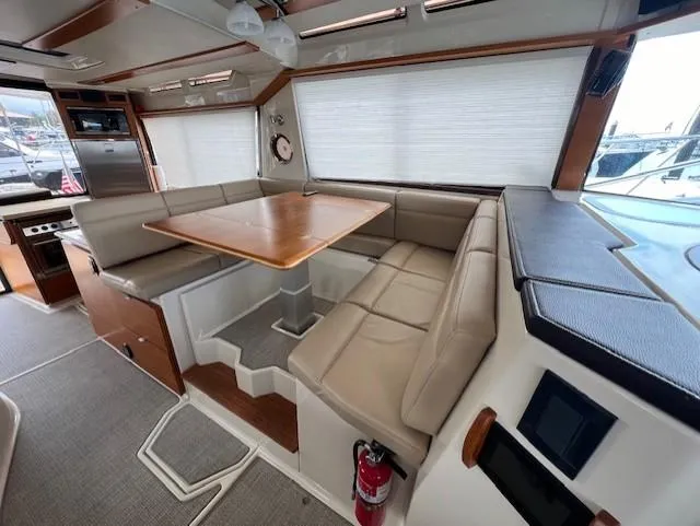 Seahorse Yacht Photos Pics 2019 Ranger Tugs R-41 CB interior with dining area and beige seating.