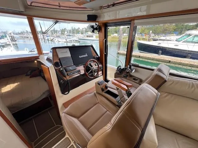 Seahorse Yacht Photos Pics Interior of 2019 Ranger Tugs R-41 CB with helm, seating, and marina view.