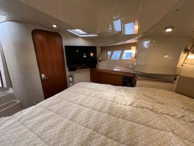 Seahorse Yacht Photos Pics 2019 Ranger Tugs R-41 CB cabin interior with bed, TV, and wooden door.