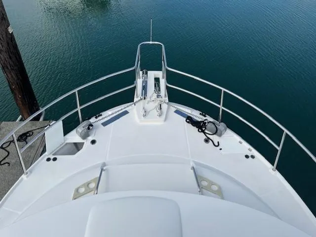 Seahorse Yacht Photos Pics 2019 Ranger Tugs R-41 CB boat deck with railing, docked on calm water.