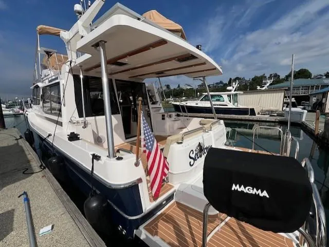 Seahorse Yacht Photos Pics 2019 Ranger Tugs R-41 CB docked, featuring spacious deck and American flag.