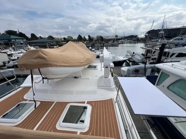 Seahorse Yacht Photos Pics 2019 Ranger Tugs R-41 CB yacht docked at a marina, featuring a covered upper deck.
