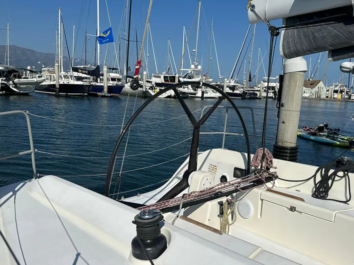Time Shaver Yacht Photos Pics Sailboat cockpit view of 2001 X-Yachts IMX40 in marina with moored boats.
