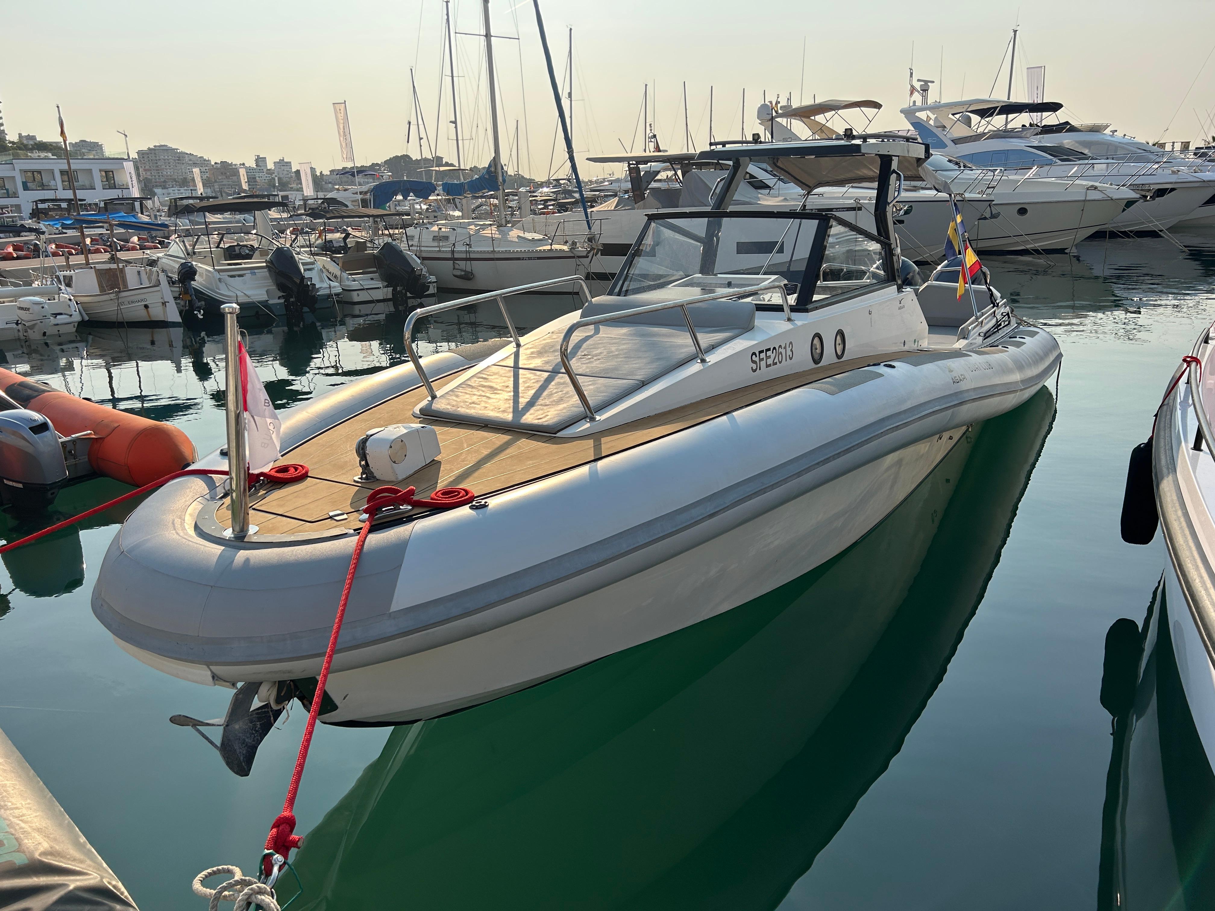 2017 Agapi 950 boat docked in a marina, surrounded by other vessels.