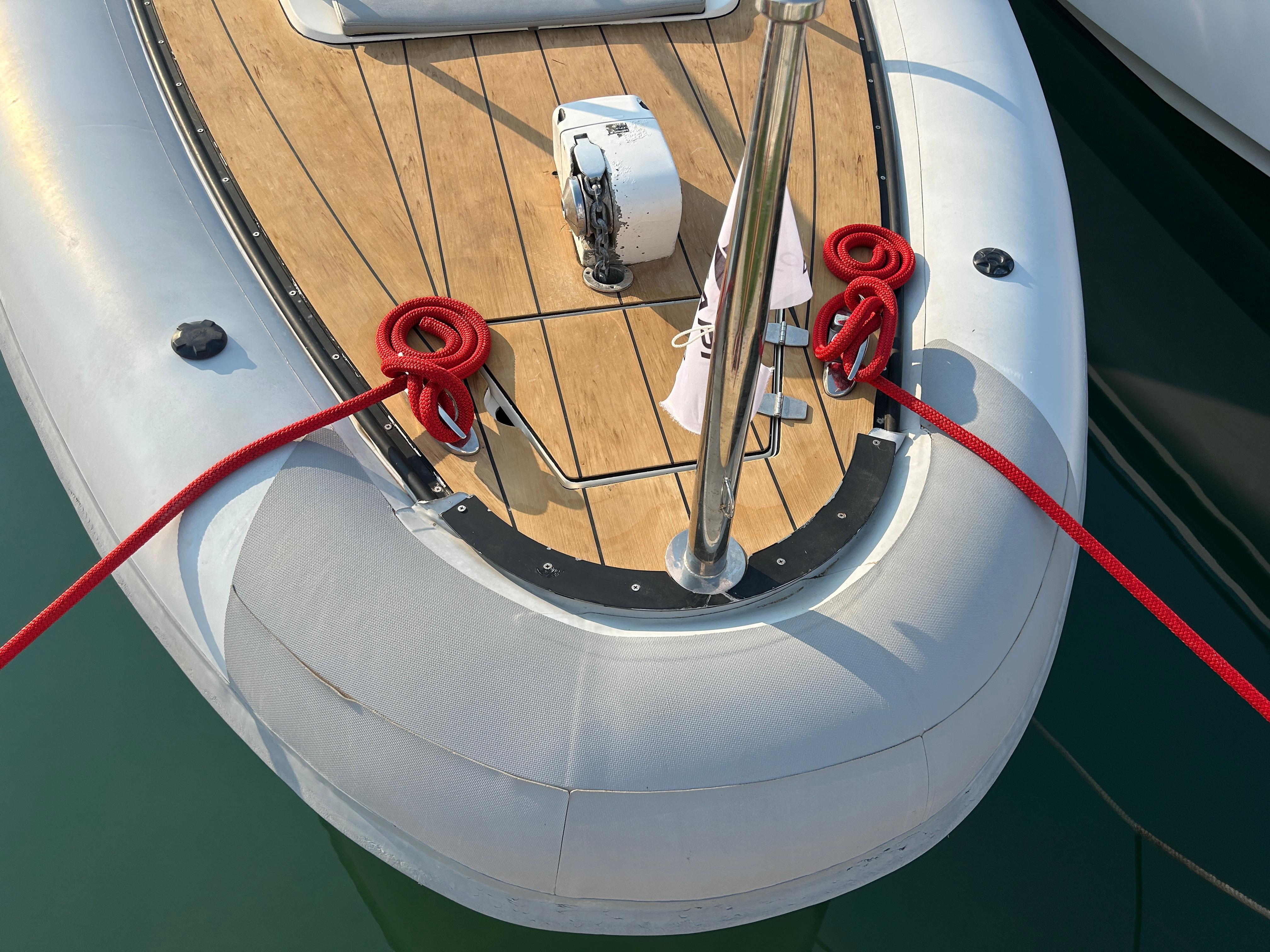 Bow of Agapi 950 boat, 2017 model, with red ropes and wooden deck.