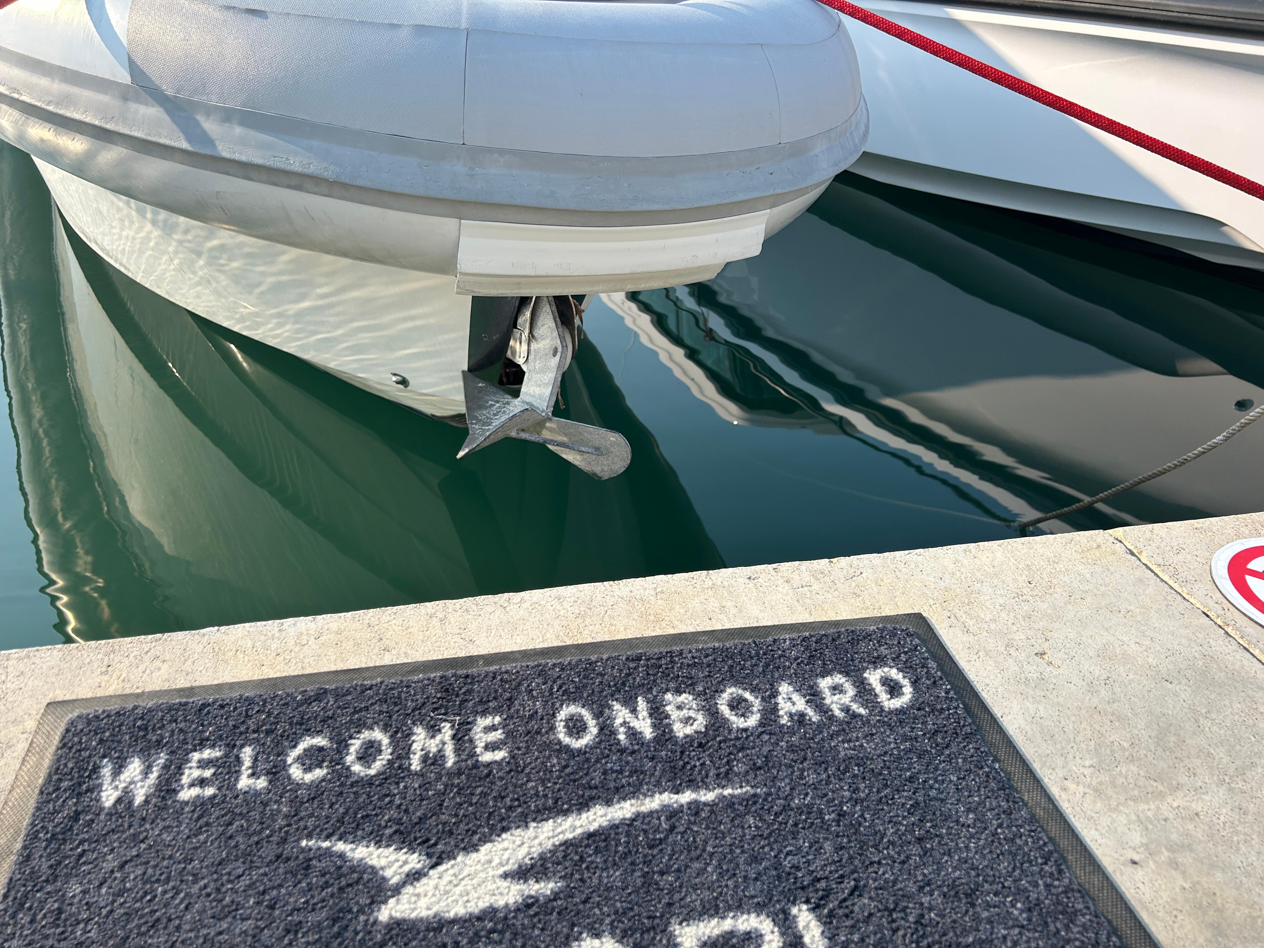 Agapi 950 boat docked, welcome mat on pier, 2017 model.