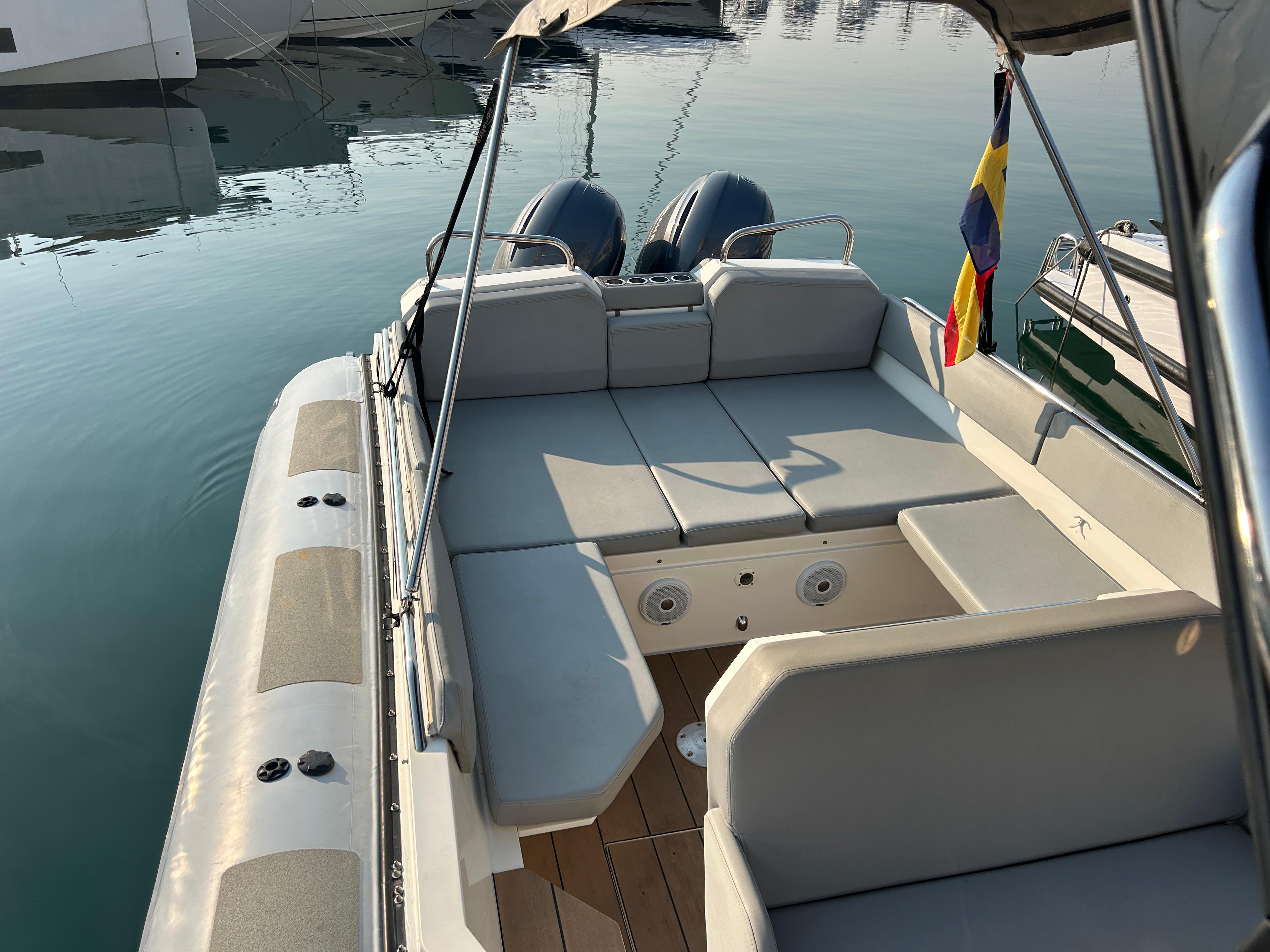 Agapi 950 boat, 2017 model, with spacious seating and dual engines, docked at marina.
