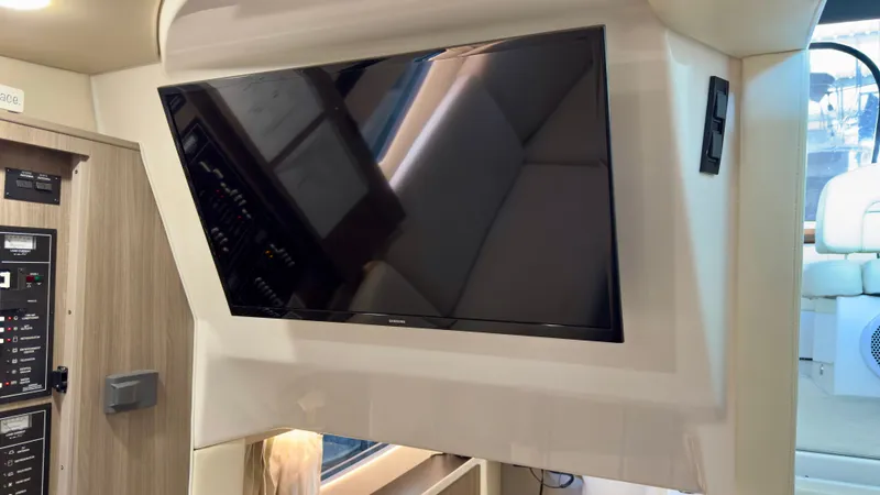  Yacht Photos Pics Flat-screen TV in 2020 Regal 33 Express yacht interior, featuring modern design and control panel.