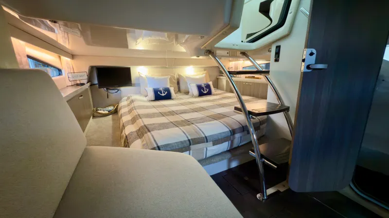  Yacht Photos Pics Luxurious interior of 2020 Regal 33 Express yacht with cozy bedding and modern amenities.